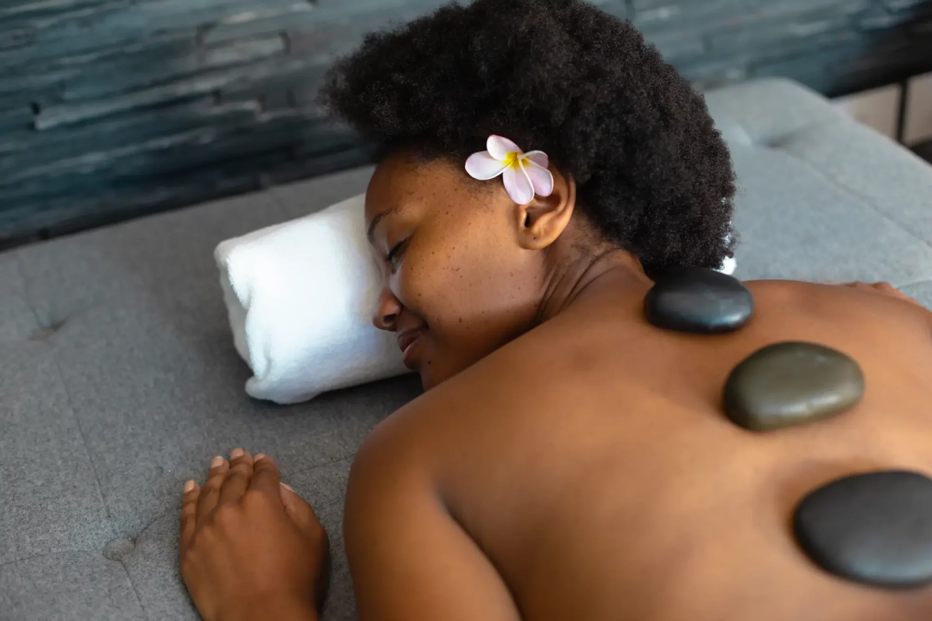 African woman getting a hot stone massage